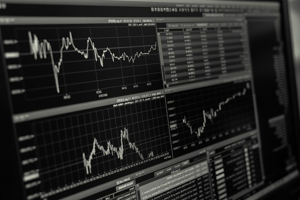Financial reports and pricing charts on a desk
